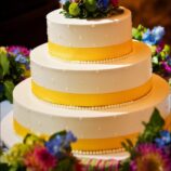 3 tier cake with yellow ribbon