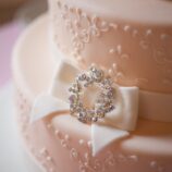 pink wedding cake with white bow